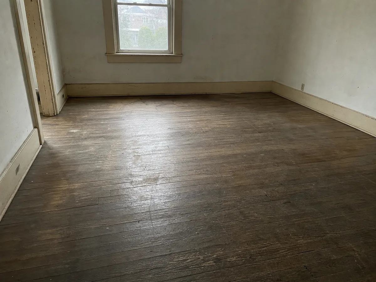 Worn scratched flooring before replacement