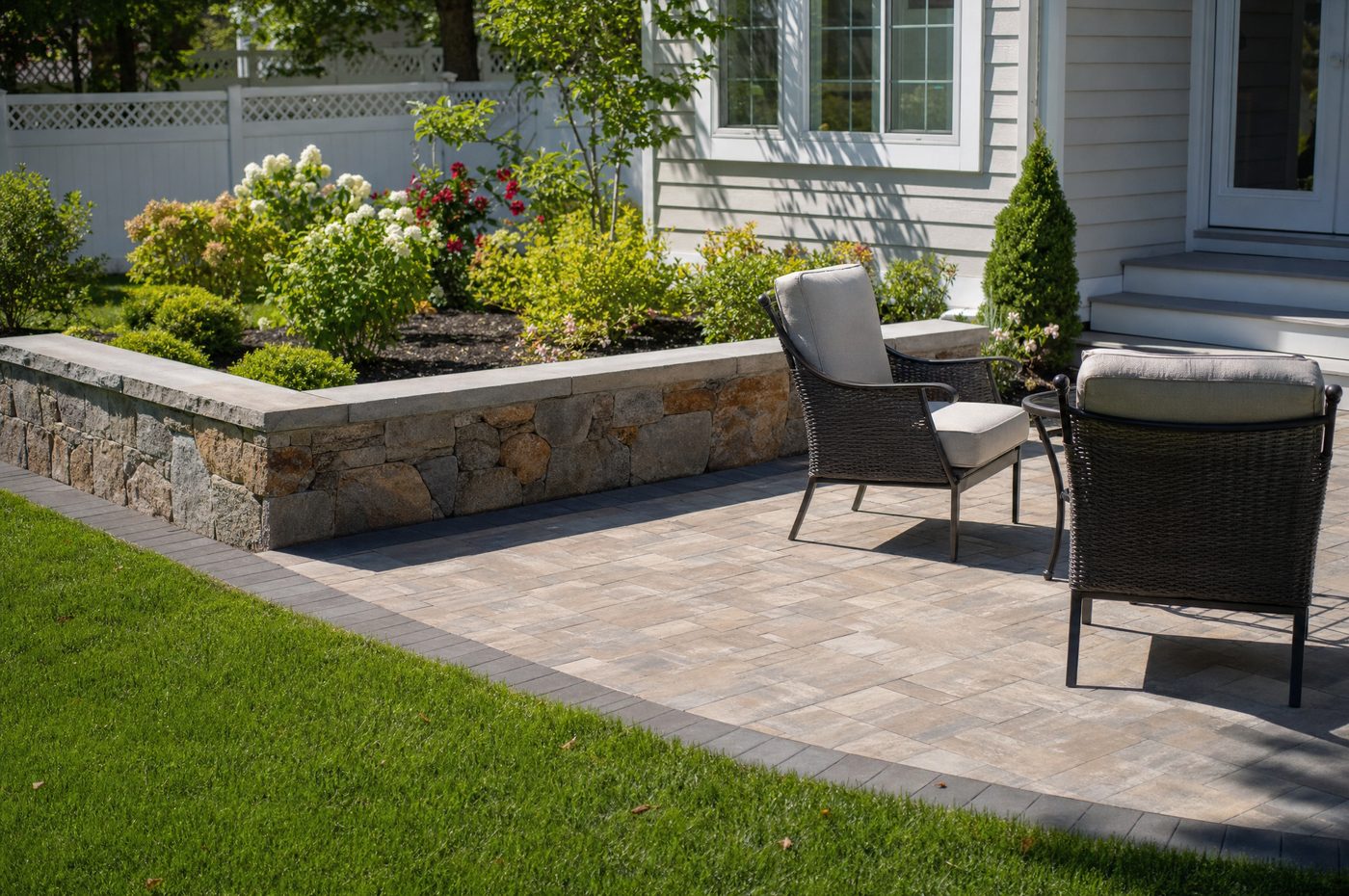 Paver patio and natural-stone seating wall built by J&T General Construction
